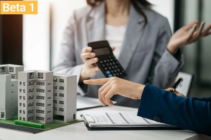 People discussing over a miniature model of a building with one person pointing and another holding a calculator.